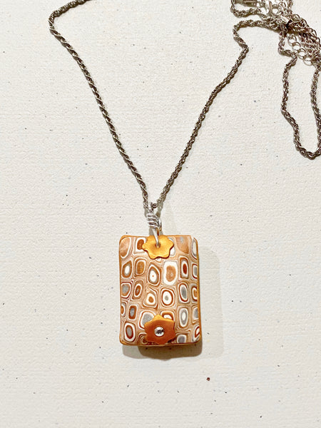 Clay Puffed Pendant with Gold, Silver and White Pattern Necklace